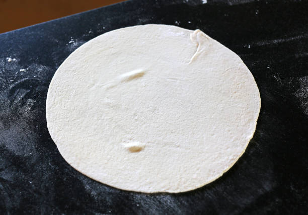 istock Dough for pizza and on the table, the size of circles. 693113394
