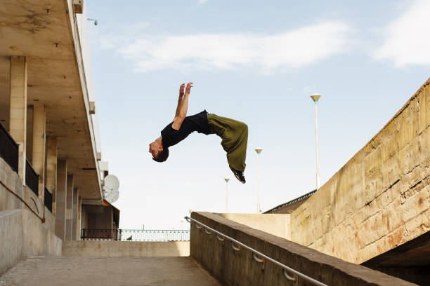 Parkour in the city Young man back flip. Parkour in the urban space. Sport in the city. Sport Activities outdoors. Acrobatics acrobatic activity photos stock pictures, royalty-free photos & images