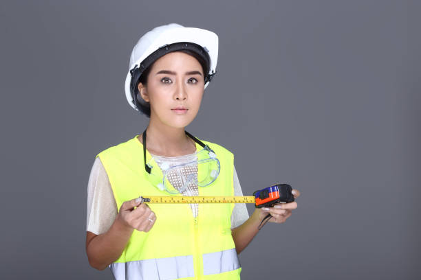 istock Asian Architect Engineer woman in white hard hat, safety vast, protector glasses goggle 693118778