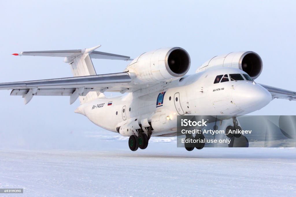 Antonov An-74 RA-74020 takes off at Barneo ice camp. Barneo Ice Camp, North Pole - April 17, 2013: Antonov An-74 RA-74020 takes off at Barneo ice camp. Aerospace Industry Stock Photo