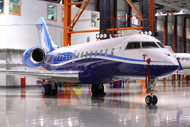 Private Bombardier Global 5000 OY-SGC standing in a hangar at Sheremetyevo international airport. stock photo
