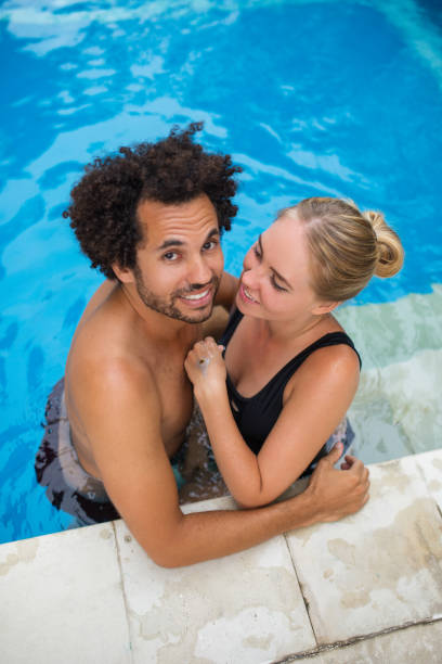 istock Happy Couple Embracing in Swimming Pool 693125222