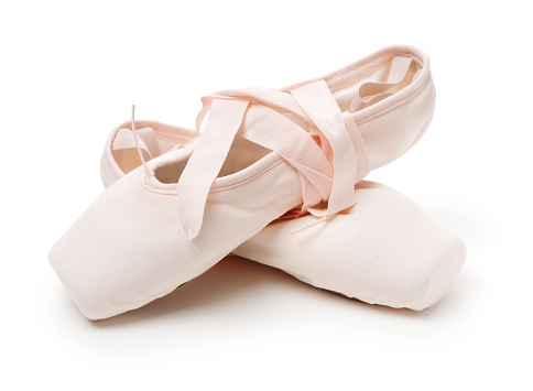 Pair of ballerina pointe shoes on white background