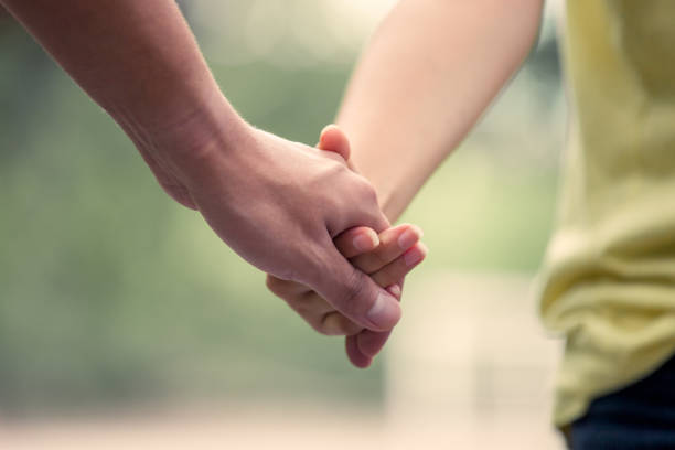 istock Young love couple holding hands and walk together 693133580