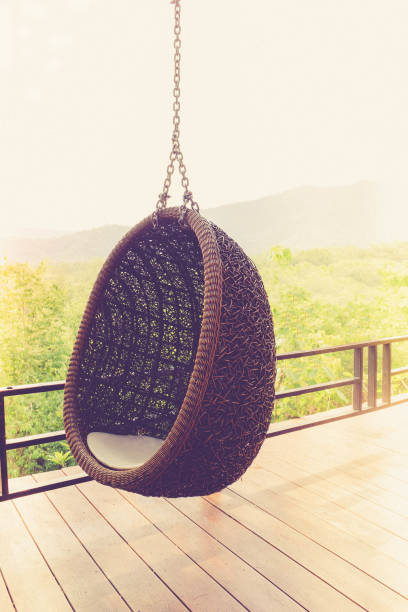 istock rattan lounge hanging chair writh white  pillow 693138804
