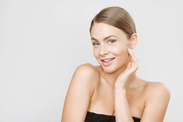 istock Beautiful young woman face close up studio on grey background 693142396