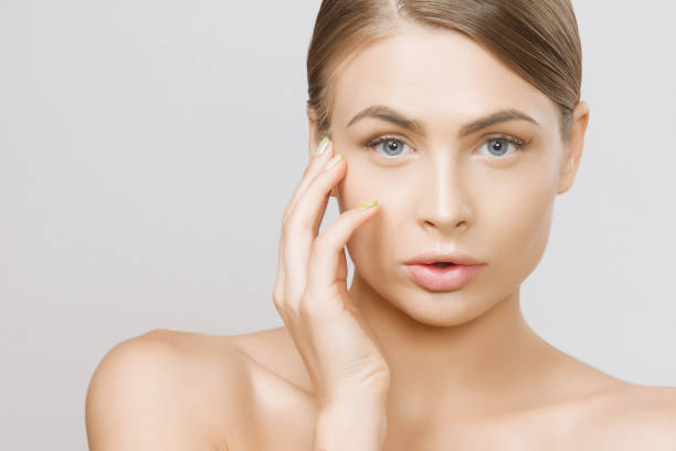 istock Beautiful young woman face close up studio on grey background 693142542