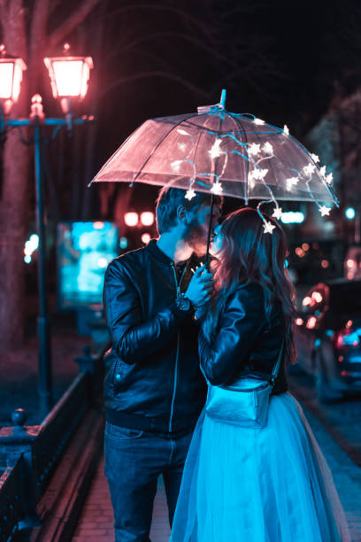 istock Guy and girl kissing under an umbrella 693148638
