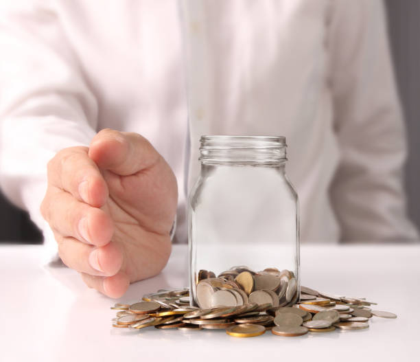 istock glass piggy  bank from  hand 693155026
