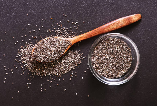 chia  seeds chia seeds on black table, raw chia seed Cirrocumulus stock pictures, royalty-free photos & images