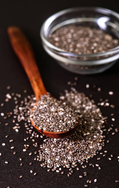 chia  seeds chia seeds on black table, raw chia seed Cirrocumulus stock pictures, royalty-free photos & images