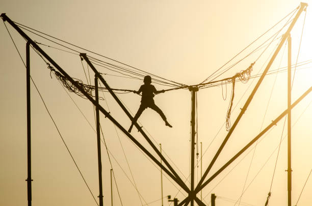 istock Trampoline rope sunset child silhouette 693165030