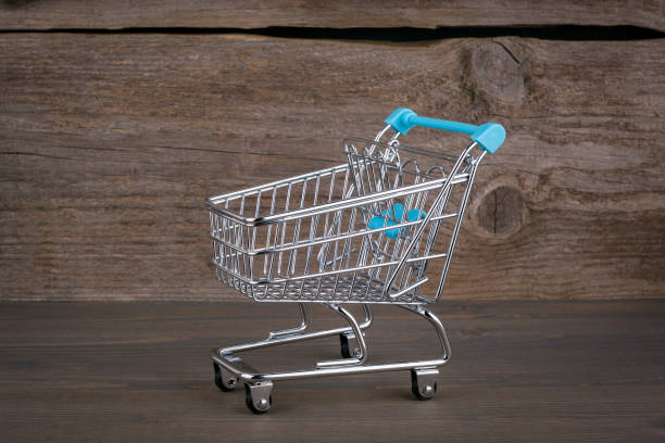 istock Purchasing cart on a dark wooden background 693167826