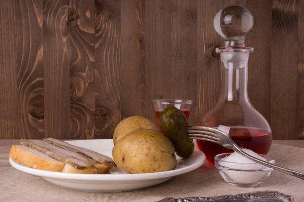 istock Russian dinner - vodka, potatoes, lard and salted cucumber 693167938
