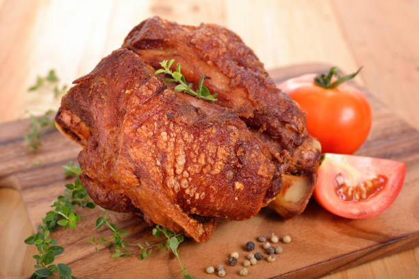 istock pork knuckle or German pork hocks on chopping board and on wooden table 693183734
