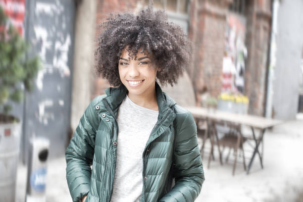 Happy young african american woman smiling, looking at camera.
