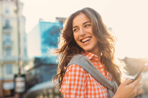 istock Beautiful woman texting outdoors 693186864