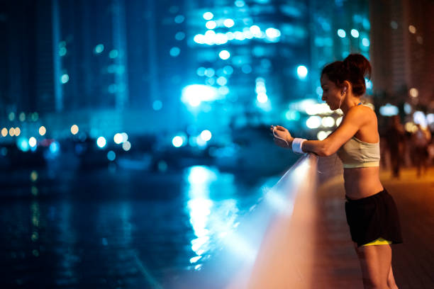 istock Woman preparing music for her workout 693187372