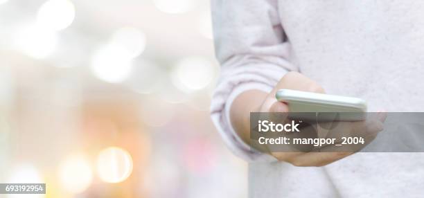 Hand Using Smart Phone Over Blur Bokeh Light Background Business And Technology Concept Digital Marketing Seo Ecommerce Network Internet Of Things Stock Photo - Download Image Now