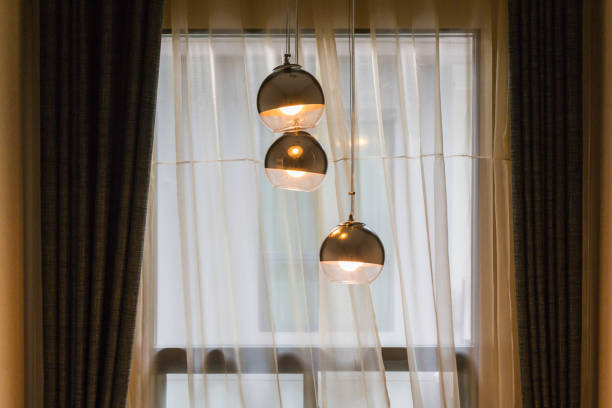 istock Modern spherical hanging lamps are the windows and curtains. 693195716