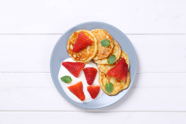 istock american pancakes with yogurt and strawberries 693196860