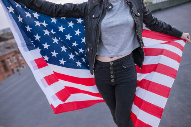istock Girl with USA flag behind the back 693199524