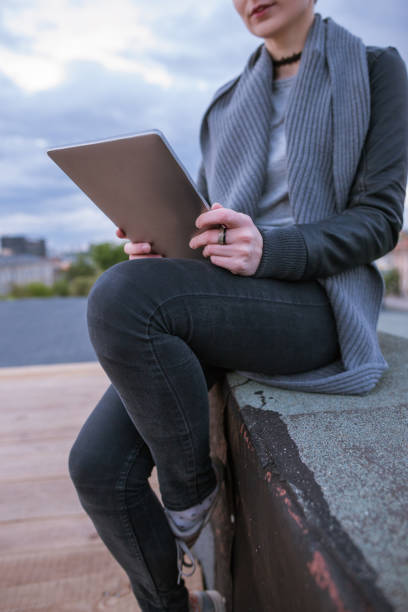 istock Girl with tablet working on roof 693199628
