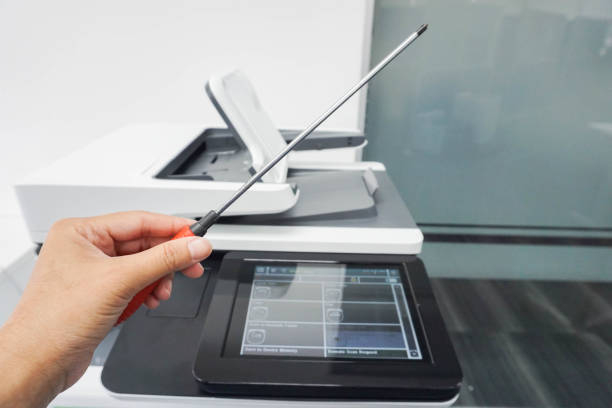 istock Service engineer left hand hold screwdriver for maintenance and repair office printer 693199770