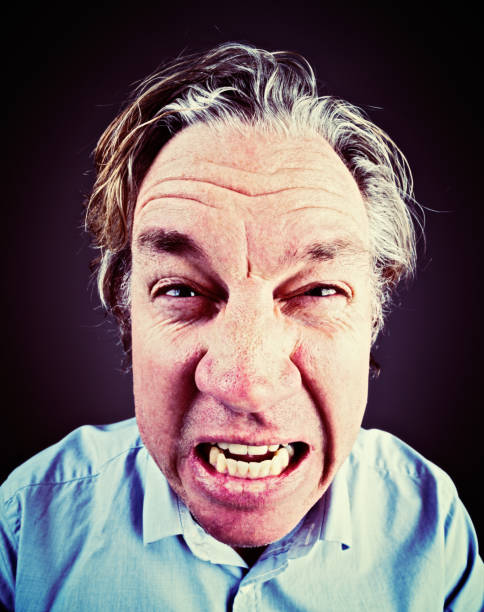 istock Portrait of tired, angry, grimacing, middle-aged man shouting 693204034