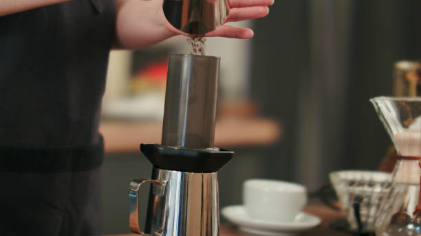 istock Barista adding grinded coffee and pouring hot water 693207974