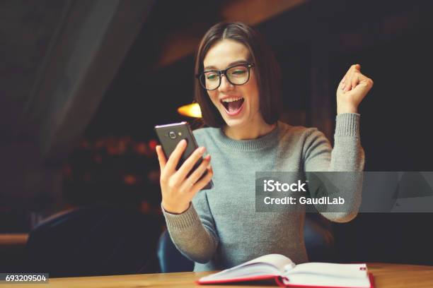 Emotional Young Attractive Female Expressing Surprise Stock Photo - Download Image Now