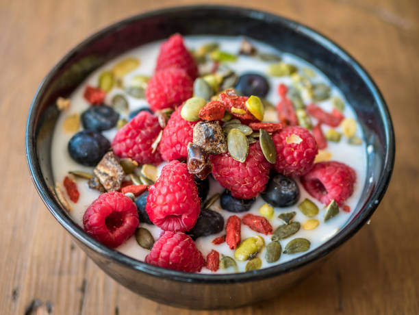 Bowl of breakfast overnight oats meal with raspberries, blueberry, wolfberry and nuts. Bowl of breakfast overnight oats meal with raspberries, blueberry, wolfberry and nuts. wolfberry berry berry fruit red stock pictures, royalty-free photos & images