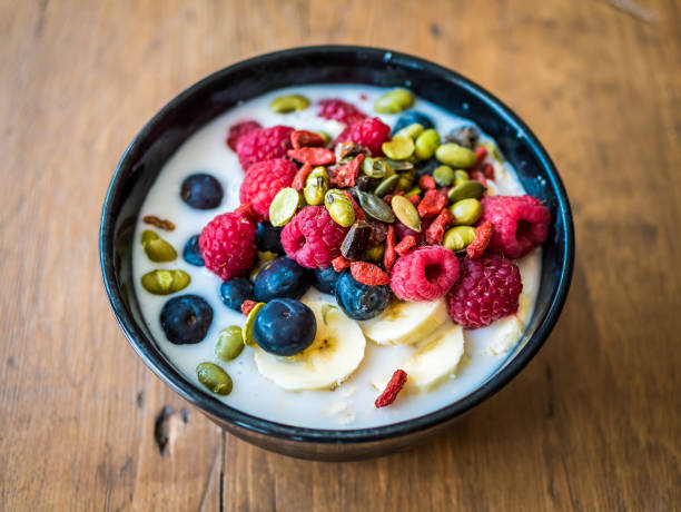 Bowl of breakfast overnight oats meal with raspberries, wolfberry blueberry, banana and nuts. Bowl of breakfast overnight oats meal with raspberries, wolfberry blueberry, banana and nuts. wolfberry berry berry fruit red stock pictures, royalty-free photos & images