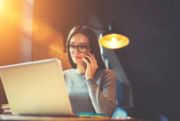 istock Concentrated female content manager in trendy eyewear working on freelance 693214984