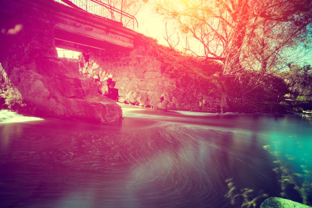 Old bridge over the river at sunset