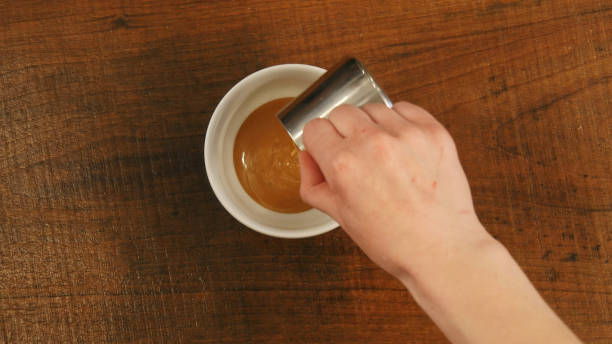 istock Barista pours caramel syrup in a cup 693215434