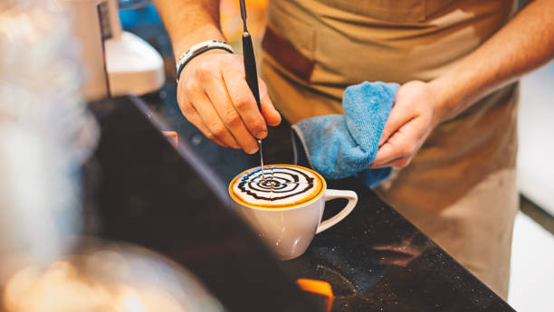 istock Barista Pouring Latte Art with Chocolate Sauce 693217022