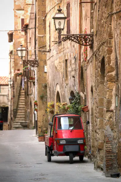 Piaggio Ape standing at the empty street of old italian town