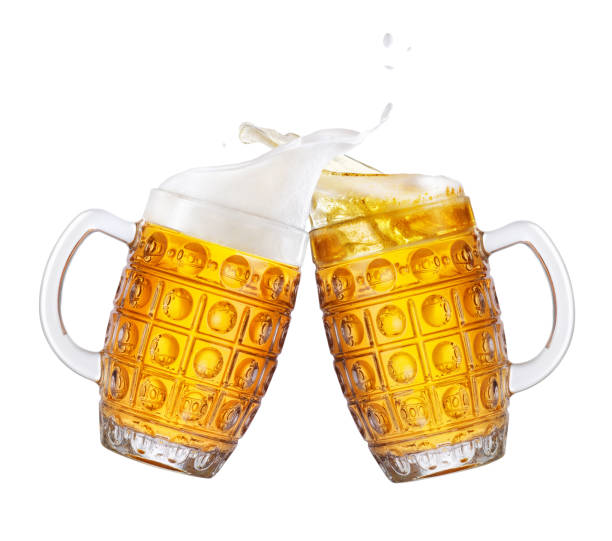 beer with splash two mugs of beer toasting creating splash isolated on white background. Pair of beer mugs making toast. Beer up. Golden beer splash beer glass splash stock pictures, royalty-free photos & images