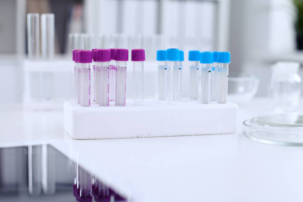 istock Research laboratory working space. Test tubes and tablet PC are lying at the table. 693234290