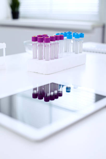 istock Research laboratory working space. Test tubes and tablet PC are lying at the table. 693234388