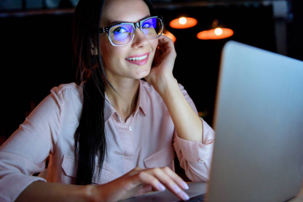 istock businesswoman working on laptop and looking at camera 693237962