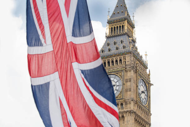 istock Union Jack fluttering in the wind with Big Ben in the background 693245452