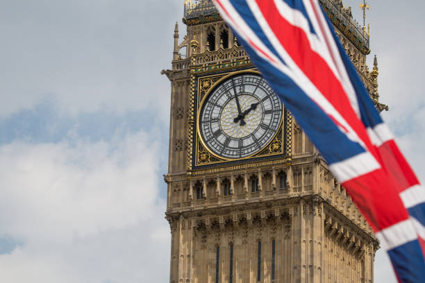 istock Union Jack fluttering in the wind with Big Ben in the background 693247768