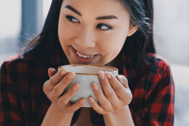 istock attractive asian girl drinking coffee in cafe, coffee break concept 693247866