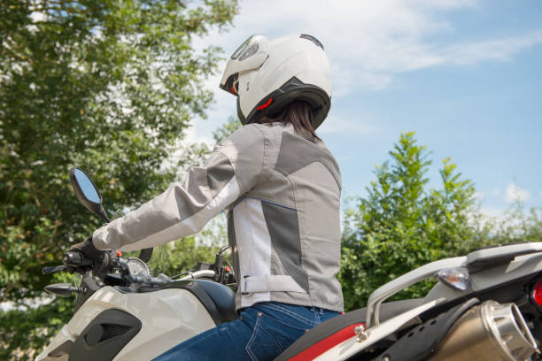 istock girl sits on a motorcycle and has a helmet on his head 693248426