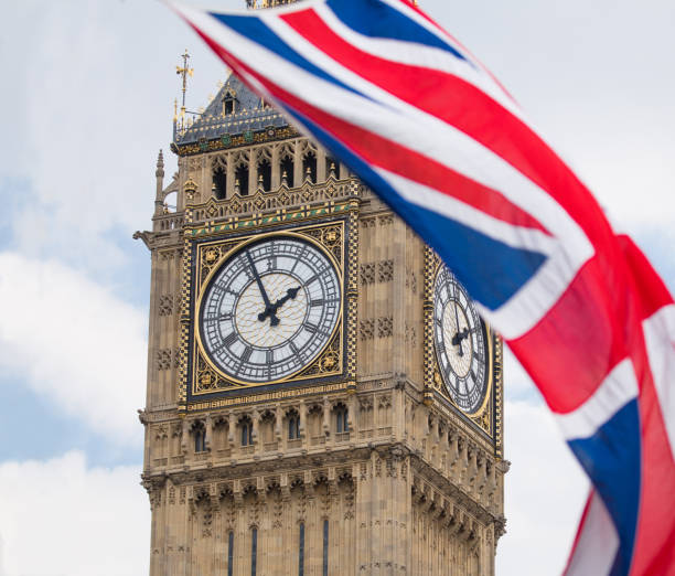 istock Union Jack fluttering in the wind with Big Ben in the background 693248460