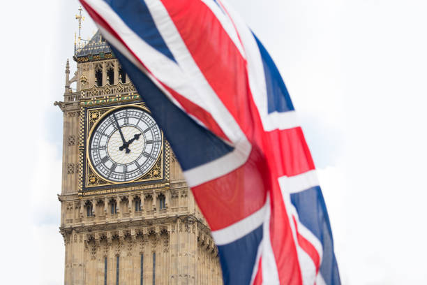 istock Union Jack fluttering in the wind with Big Ben in the background 693248708