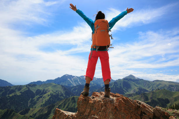 istock young woman hiker hiking on mountain top 693251148