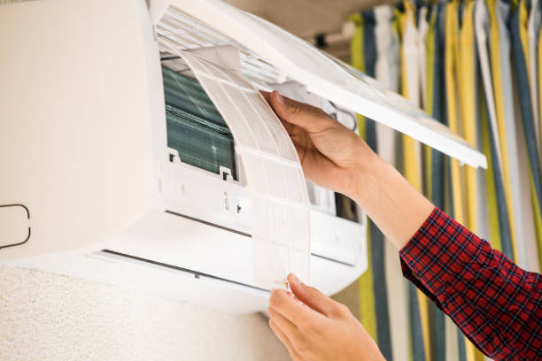 istock Man installs or repairs an air conditioner. 693251490